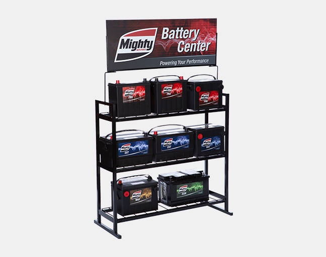 Mighty-branded vehicle battery rack stocked in a shop back room